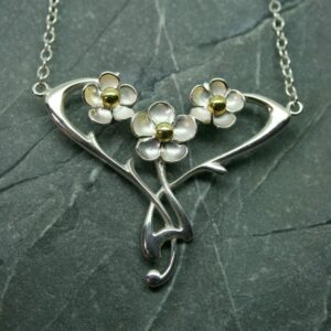 Silver three flower necklace with brass detail
