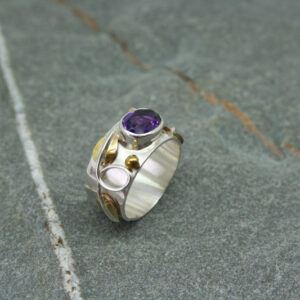 Wide silver amethyst set ring with brass lea detail